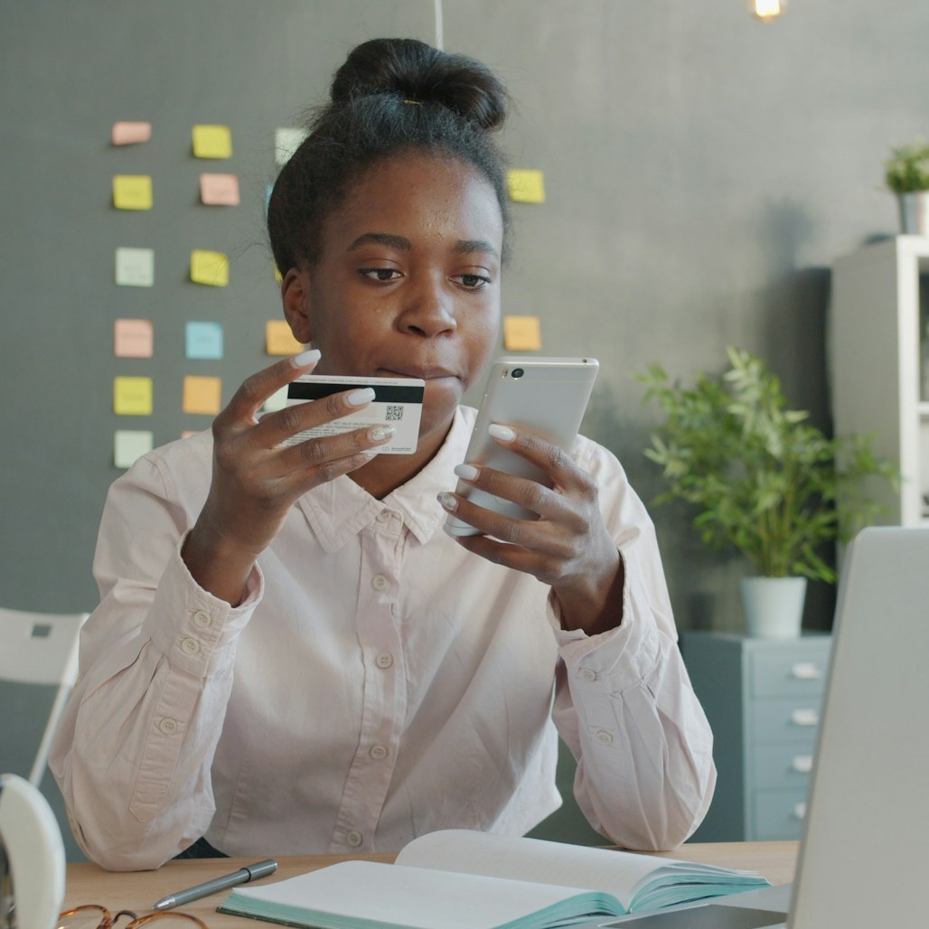 Woman paying with her card and phone